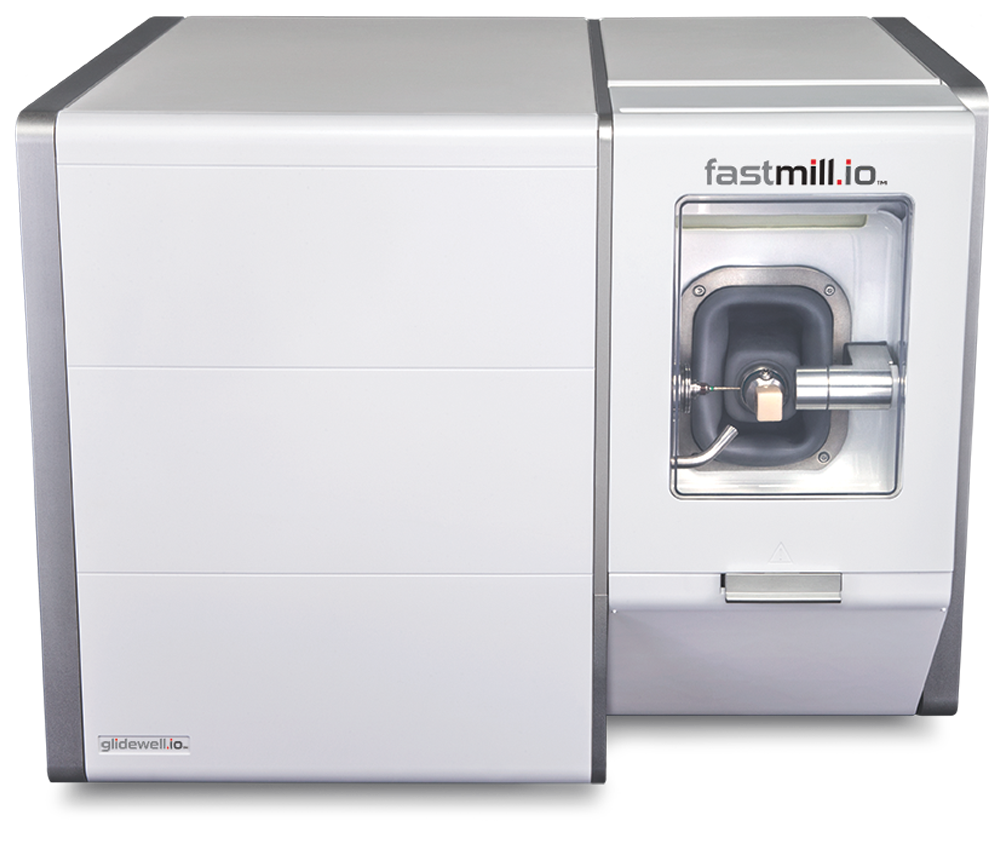 Dental milling machine with white chamber and automated tool carousel for chairside crown fabrication.