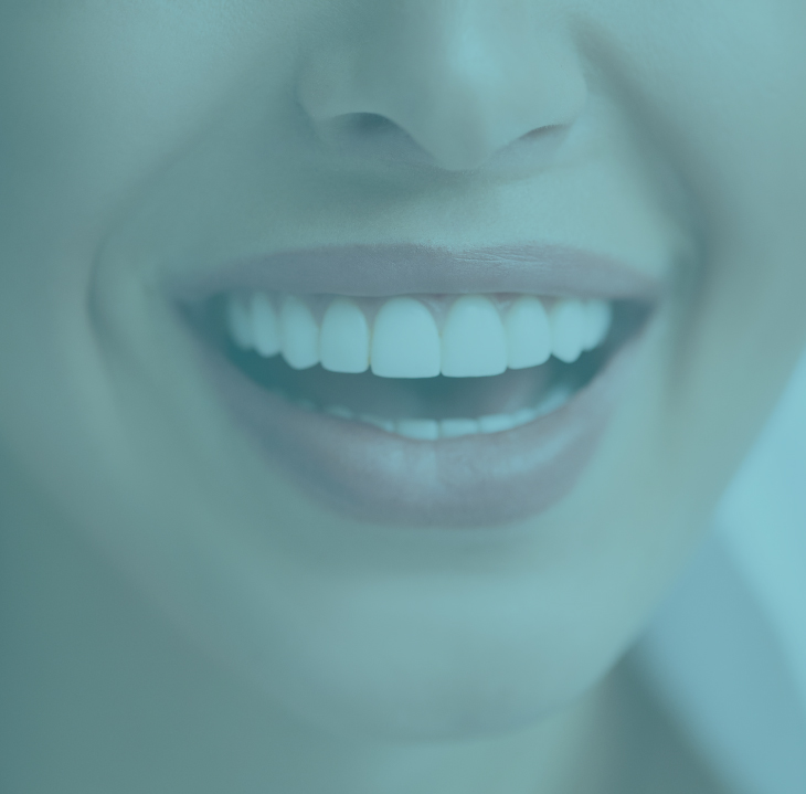 Close-up of person smiling brightly, displaying white healthy teeth in dental care context.